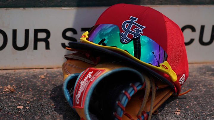 Mar 20, 2018; Jupiter, FL, USA; A St. Louis Cardinals hat with sunglasses sits on a glove in the dugout during a spring training game against the New York Mets at Roger Dean Stadium. Mandatory Credit: Jasen Vinlove-Imagn Images