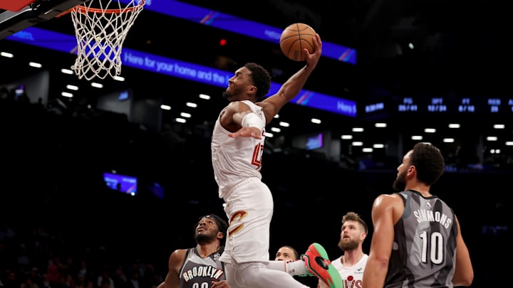Dec 16, 2024; Brooklyn, New York, USA; Cleveland Cavaliers guard Donovan Mitchell (45) dunks against Brooklyn Nets center Day'Ron Sharpe (20) and guards Tyrese Martin (13) and Ben Simmons (10) during the second quarter at Barclays Center. Mandatory Credit: Brad Penner-Imagn Images Dec 16, 2024; Brooklyn, New York, USA; Cleveland Cavaliers guard Donovan Mitchell (45) dunks against Brooklyn Nets center Day'Ron Sharpe (20) and guards Tyrese Martin (13) and Ben Simmons (10) during the second quarter at Barclays Center. Mandatory Credit: Brad Penner-Imagn Images