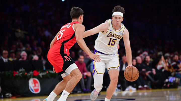 Dec 25, 2025; Los Angeles, California, USA; Los Angeles Lakers guard Austin Reaves (15) moves the ball against Houston Rockets guard Reed Sheppard (15) during the first half at Crypto.com Arena. Mandatory Credit: Gary A. Vasquez-Imagn Images