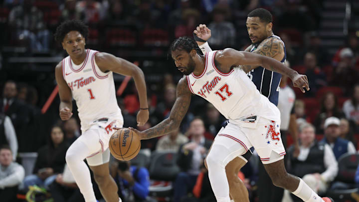 Jan 31, 2026; Houston, Texas, USA; Houston Rockets forward Tari Eason (17) gets a loose ball away from Dallas Mavericks forward P.J. Washington (25) during the first quarter at Toyota Center. Mandatory Credit: Troy Taormina-Imagn Images