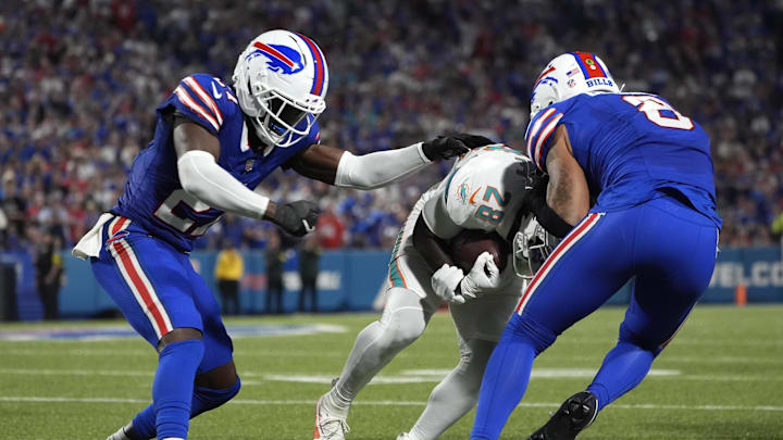 Buffalo Bills cornerback Tre'Davious White and linebacker Terrel Bernard tackle Miami Dolphins running back De'von Achane.