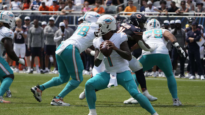 Aug 10, 2025; Chicago, Illinois, USA; Miami Dolphins quarterback Tua Tagovailoa (1) looks to pass the ball against the Chicago Bears during the first half at Soldier Field. 