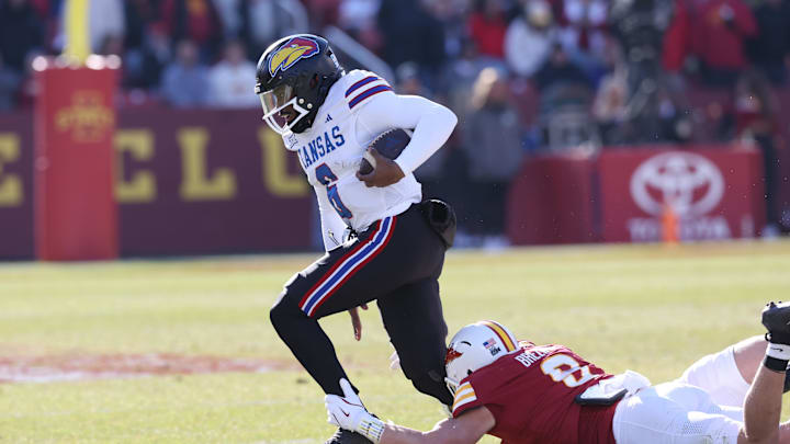 Nov 22, 2025; Ames, Iowa, USA; Kansas Jayhawks quarterback Jalon Daniels (6) is tackled by Iowa State Cyclones linebacker Zachary Lovett (0) during the first half at Jack Trice Stadium. Mandatory Credit: Reese Strickland-Imagn Images