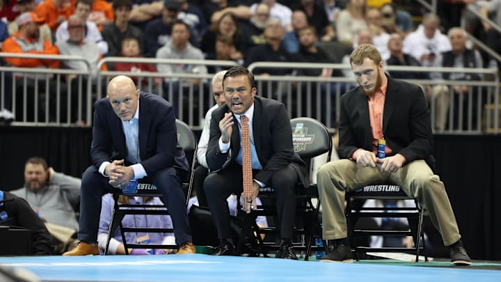 Mar 23, 2024; Kansas City, MO, USA; Virginia Tech head coach Tony Robie watches the 149 pound Virginia Tech Hokies wrestler Caleb Henson compete against Michigan Wolverines wrestler Austin Gomez.   Mandatory Credit: Reese Strickland-Imagn Images