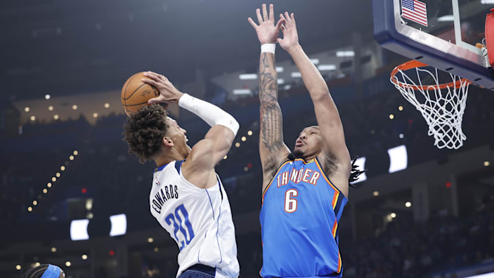 Jan 23, 2025; Oklahoma City, Oklahoma, USA; Oklahoma City Thunder forward Jaylin Williams (6) defends a shot by Dallas Mavericks forward Kessler Edwards (20) during the first quarter at Paycom Center. Mandatory Credit: Alonzo Adams-Imagn Images