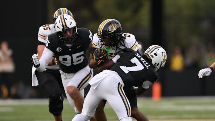 Oct 25, 2025; Nashville, Tennessee, USA; Missouri Tigers wide receiver Joshua Manning (0) is tackled by Vanderbilt Commodores safety Marlen Sewell (7) during the third quarter at FirstBank Stadium. Mandatory Credit: Steve Roberts-Imagn Images Oct 25, 2025; Nashville, Tennessee, USA; Missouri Tigers wide receiver Joshua Manning (0) is tackled by Vanderbilt Commodores safety Marlen Sewell (7) during the third quarter at FirstBank Stadium. Mandatory Credit: Steve Roberts-Imagn Images