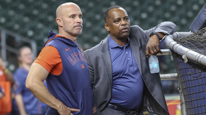 Jun 28, 2025; Houston, Texas, USA; Houston Astros manager Joe Espada (left) and general manager Dana Brown (right) talk on the field before the game against the Chicago Cubs at Daikin Park. Mandatory Credit: Troy Taormina-Imagn Images