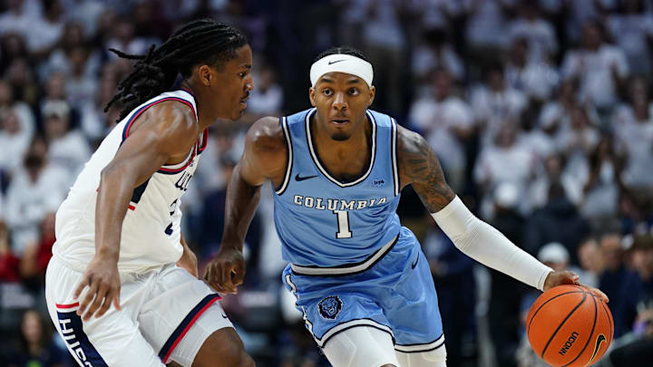 Nov 10, 2025; Storrs, Connecticut, USA; Columbia Lions guard Avery Brown (1) drives the ball against UConn Huskies guard Silas Demary Jr. (2)  in the first half at Harry A. Gampel Pavilion.