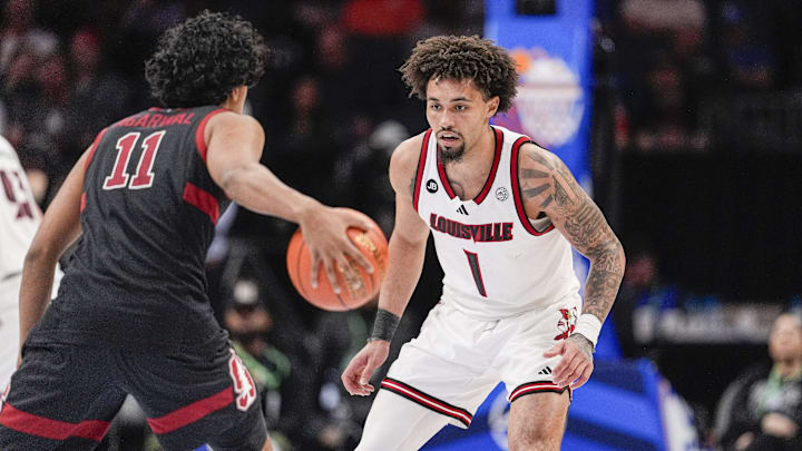Mar 13, 2025; Charlotte, NC, USA; Louisville Cardinals guard Chucky Hepburn (24) on defense against Stanford Cardinal guard Ryan Agarwal (11) during the second half at Spectrum Center. Mandatory Credit: Jim Dedmon-Imagn Images