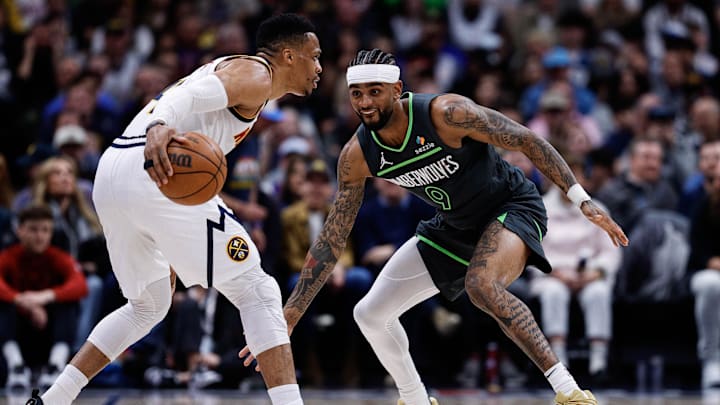 Apr 1, 2025; Denver, Colorado, USA; Denver Nuggets guard Russell Westbrook (4) controls the ball as Minnesota Timberwolves guard Nickeil Alexander-Walker (9) guards in the second quarter at Ball Arena. Mandatory Credit: Isaiah J. Downing-Imagn Images