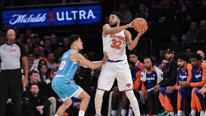 Dec 5, 2024; New York, New York, USA; New York Knicks center Karl-Anthony Towns (32) looks to pass the ball as Charlotte Hornets guard Josh Green (10) defends during the first half at Madison Square Garden. Mandatory Credit: John Jones-Imagn Images