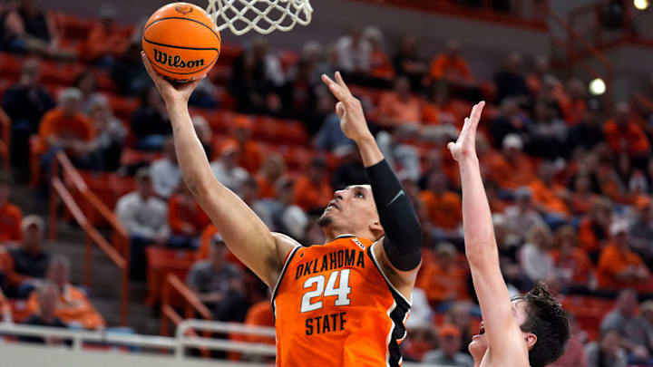 Oklahoma State Cowboys forward Patrick Suemnick (24) goes past Green Bay Phoenix forward Marcus Hall (13) during a college basketball game between the Oklahoma State Cowboys (OSU) and the Green Bay Phoenix at Gallagher-Iba Arena in Stillwater, Okla., Monday, Nov. 4, 2024.