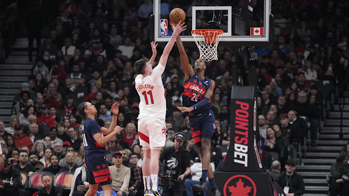 Mar 10, 2025; Toronto, Ontario, CAN; Washington Wizards center Alex Sarr (20) blocks a shot by Toronto Raptors center Colin Castleton (11) during the first half at Scotiabank Arena. Mandatory Credit: John E. Sokolowski-Imagn Images