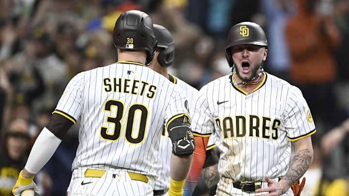 May 12, 2025; San Diego, California, USA; San Diego Padres center fielder Jackson Merrill (3) is congratulated by Gavin Sheets (30) after scoring during the third inning against the Los Angeles Angels at Petco Park. Mandatory Credit: Denis Poroy-Imagn Images