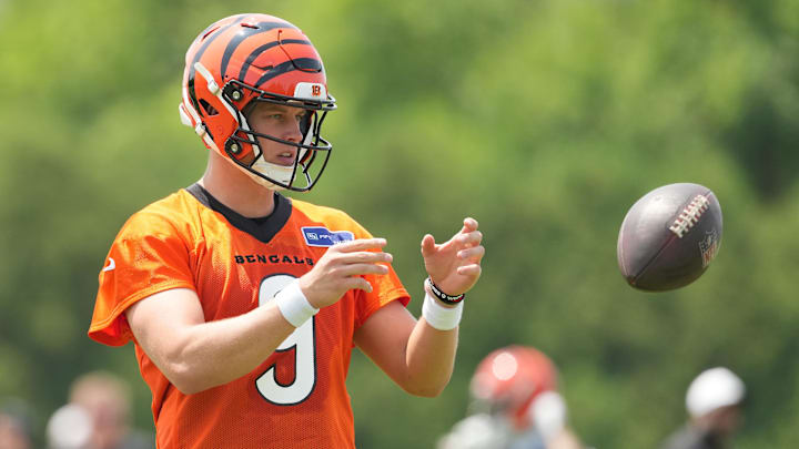 Jun 10, 2025; Cincinnati, OH, USA; Cincinnati Bengals quarterback Joe Burrow (9) catches a ball during practice at Paycor Stadium. Mandatory Credit: Kareem Elgazzar-Imagn Images