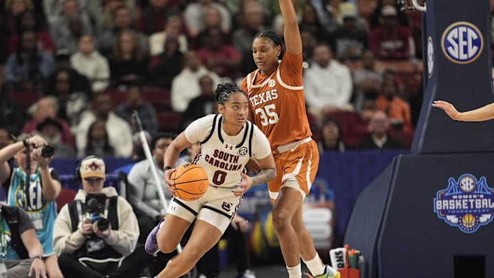 March 9, 2025; Greenville, SC, USA; South Carolina Gamecocks guard Te-Hina Paopao (0) goes to the basket around Texas Longhorns forward Madison Booker (35) during the first half at Bon Secours Wellness Arena. Mandatory Credit: Jim Dedmon-Imagn Images