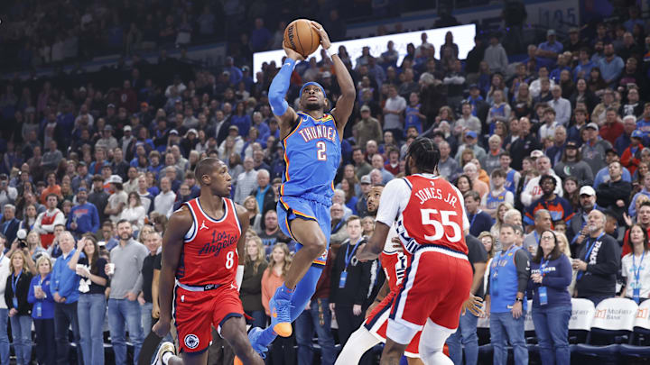 Jan 2, 2025; Oklahoma City, Oklahoma, USA; Oklahoma City Thunder guard Shai Gilgeous-Alexander (2) shoots between Los Angeles Clippers guard Kris Dunn (8) and forward Derrick Jones Jr. (55) during the first quarter at Paycom Center. Mandatory Credit: Alonzo Adams-Imagn Images