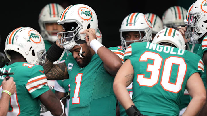 Miami Dolphins quarterback Tua Tagovailoa (1) puts his helmet on before heading out to warm-up
