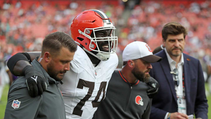 Cleveland Browns offensive tackle Hakeem Adeniji (74) is helped off the field during the second half of an NFL preseason football game at Cleveland Browns Stadium, Saturday, Aug. 17, 2024, in Cleveland, Ohio.