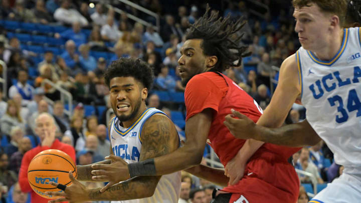 Feb 3, 2026; Los Angeles, California, USA;  UCLA Bruins guard Donovan Dent (2) is defended by Rutgers Scarlet Knights forward Bryce Dortch (4) as UCLA Bruins forward Tyler Bilodeau (34) sets a screen in the first half at Pauley Pavilion presented by Wescom Financial. Mandatory Credit: Jayne Kamin-Oncea-Imagn Images