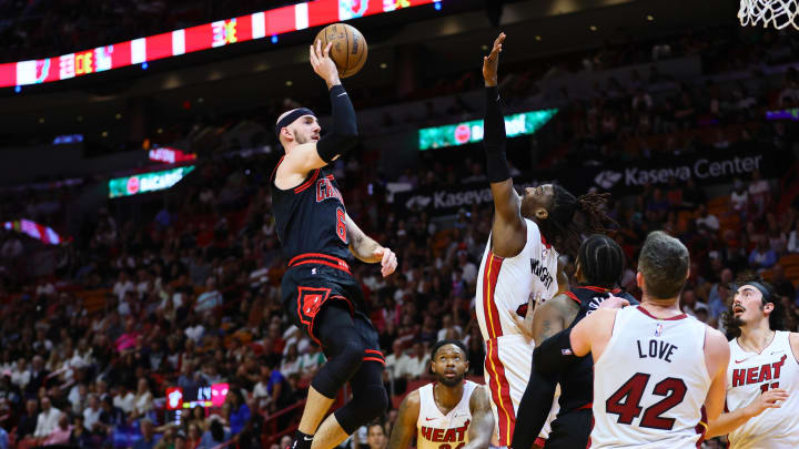 Apr 19, 2024; Miami, Florida, USA; Chicago Bulls guard Alex Caruso (6) shoots the basketball over Miami Heat guard Delon Wright (4) in the first quarter during a play-in game of the 2024 NBA playoffs at Kaseya Center. Mandatory Credit: Sam Navarro-USA TODAY Sports Apr 19, 2024; Miami, Florida, USA; Chicago Bulls guard Alex Caruso (6) shoots the basketball over Miami Heat guard Delon Wright (4) in the first quarter during a play-in game of the 2024 NBA playoffs at Kaseya Center. Mandatory Credit: Sam Navarro-USA TODAY Sports