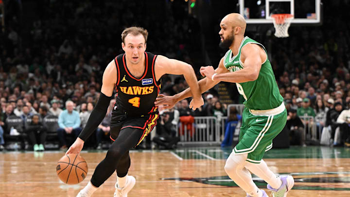 Jan 28, 2026; Boston, Massachusetts, USA; Atlanta Hawks guard Luke Kennard (4) drives to the basket against Boston Celtics guard Derrick White (9) during the first half at the TD Garden. Mandatory Credit: Brian Fluharty-Imagn Images