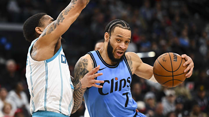 LA Clippers guard Amir Coffey moves the ball against Charlotte Hornets guard Nick Smith Jr. Mandatory Credit: Jonathan Hui-Imagn Images
