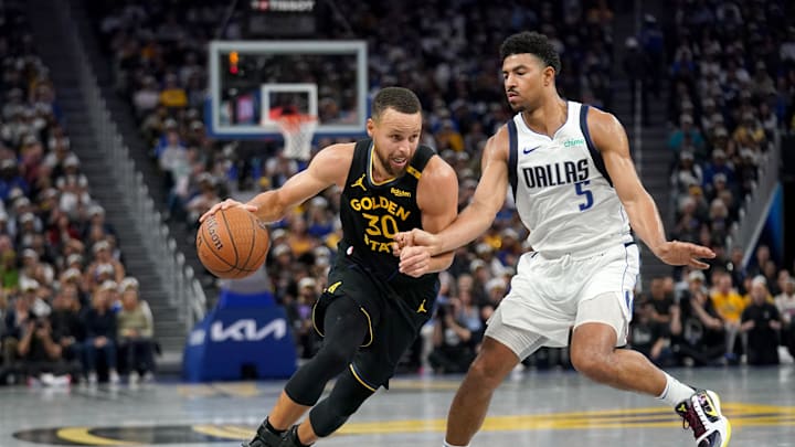 Nov 12, 2024; San Francisco, California, USA; Golden State Warriors guard Stephen Curry (30) dribbles past Dallas Mavericks guard Quentin Grimes (5) in the third quarter at the Chase Center. 