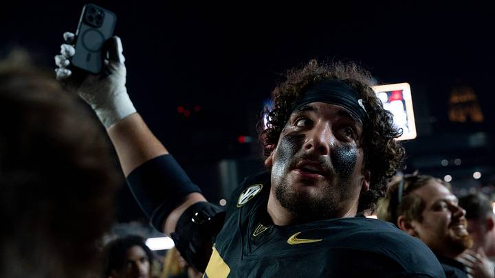 Vanderbilt Commodores offensive lineman Cade McConnell (70) documents the mayhem as fans take down the south end zone goal post after beating No. 1 Alabama 40-35 at Vanderbilt Stadium in Nashville, Tenn., Saturday, Oct. 5, 2024. Vanderbilt Commodores offensive lineman Cade McConnell (70) documents the mayhem as fans take down the south end zone goal post after beating No. 1 Alabama 40-35 at Vanderbilt Stadium in Nashville, Tenn., Saturday, Oct. 5, 2024.
