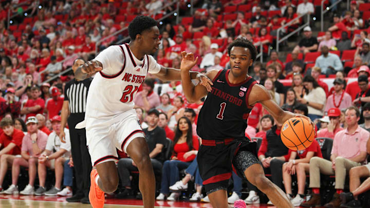 Mar 7, 2026; Raleigh, North Carolina, USA;  Stanford Cardinal guard Ebuka Okorie (1) drive the ball around NC State Wolfpack guard Terrance Arceneaux (21) during the second half at Lenovo Center. Mandatory Credit: Zachary Taft-Imagn Images