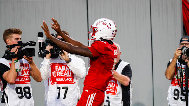 Aug 28, 2025; Raleigh, North Carolina, USA; North Carolina State Wolfpack quarterback CJ Bailey (11) celebrates a touchdown during the first half of the game against East Carolina Pirates at Carter-Finley Stadium. Mandatory Credit: Jaylynn Nash-Imagn Images Aug 28, 2025; Raleigh, North Carolina, USA; North Carolina State Wolfpack quarterback CJ Bailey (11) celebrates a touchdown during the first half of the game against East Carolina Pirates at Carter-Finley Stadium. Mandatory Credit: Jaylynn Nash-Imagn Images