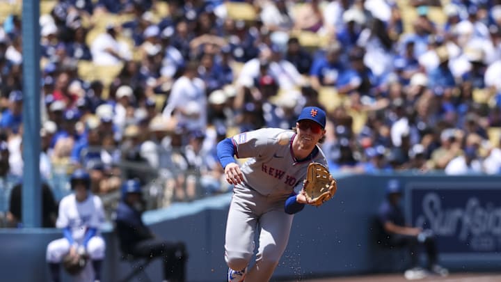 Jun 5, 2025; Los Angeles, California, USA; New York Mets third base Brett Baty (7) fields the ball during the second inning against the Los Angeles Dodgers at Dodger Stadium. Mandatory Credit: Jason Parkhurst-Imagn Images