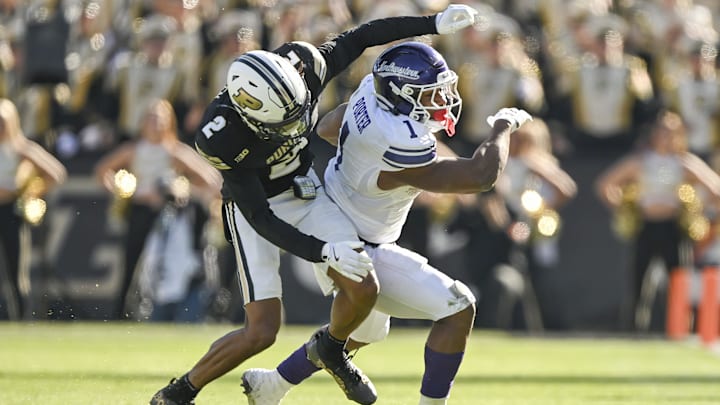 Nov 2, 2024; West Lafayette, Indiana, USA; Purdue Boilermakers defensive back Nyland Green (2) tackles Northwestern Wildcats running back Cam Porter (1) during the second half at Ross-Ade Stadium. Mandatory Credit: Marc Lebryk-Imagn Images
