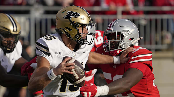 Nov 9, 2024; Columbus, Ohio, USA; Purdue Boilermakers quarterback Ryan Browne (15) is pursued by Ohio State Buckeyes defensive end Joshua Mickens (52) during the second halfat Ohio Stadium. Mandatory Credit: Barbara Perenic/USA TODAY Network via Imagn Images