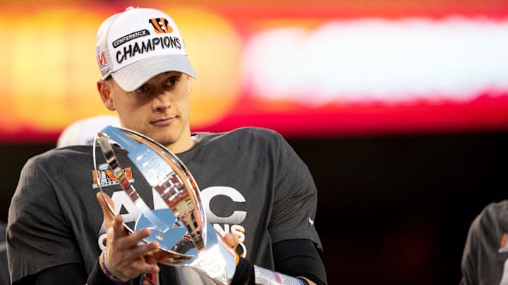 Cincinnati Bengals quarterback Joe Burrow (9) holds the AFC Championship trophy after the AFC