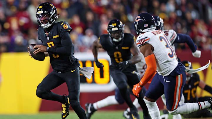 Commanders quarterback Jayden Daniels (5) runs the ball against the Bears in 2024. Commanders quarterback Jayden Daniels (5) runs the ball against the Bears in 2024.