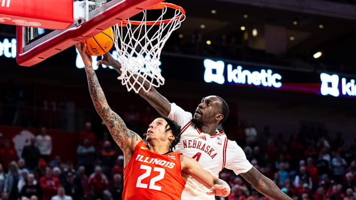 Jan 30, 2025; Lincoln, Nebraska, USA; Illinois Fighting Illini guard Tre White (22) shoots the ball against Nebraska Cornhuskers forward Juwan Gary (4) during overtime at Pinnacle Bank Arena. Mandatory Credit: Dylan Widger-Imagn Images