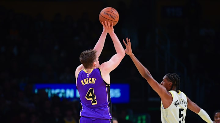 Nov 19, 2024; Los Angeles, California, USA; Los Angeles Lakers guard Dalton Knecht (4) shoots a three point basket against Utah Jazz forward Cody Williams (5) during the second half at Crypto.com Arena. Mandatory Credit: Gary A. Vasquez-Imagn Images