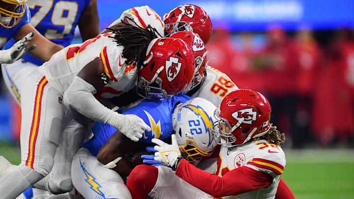 Dec 16, 2021; Inglewood, California, USA; Los Angeles Chargers tight end Jared Cook (87) is brought down by Kansas City Chiefs free safety Tyrann Mathieu (32) during the second half at SoFi Stadium. Mandatory Credit: Gary A. Vasquez-Imagn Images