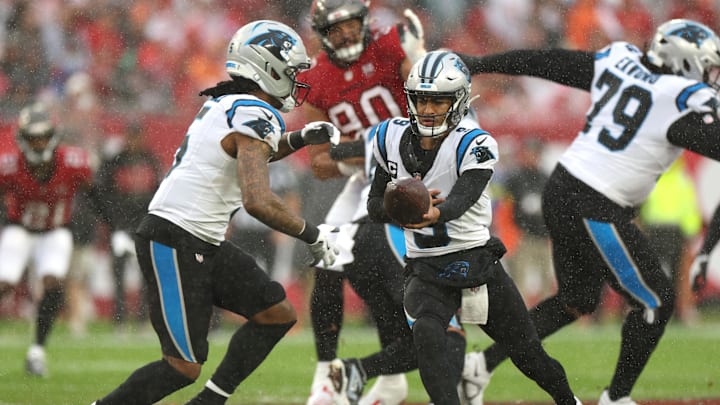 Jan 3, 2026; Tampa, Florida, USA; Carolina Panthers quarterback Bryce Young (9) hands off the ball to running back Rico Dowdle (5) in the first half against the Tampa Bay Buccaneers at Raymond James Stadium. Mandatory Credit: Nathan Ray Seebeck-Imagn Images