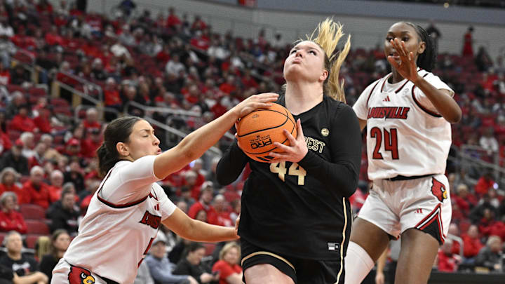 Feb 12, 2026; Louisville, Kentucky, USA;  Louisville Cardinals guard Rebekah Graves (5) strips the ball from Wake Forest Demon Deacons forward Emily Johns (44) during the second half at KFC Yum! Center. Louisville defeated Wake Forest 86-67. Mandatory Credit: Jamie Rhodes-Imagn Images