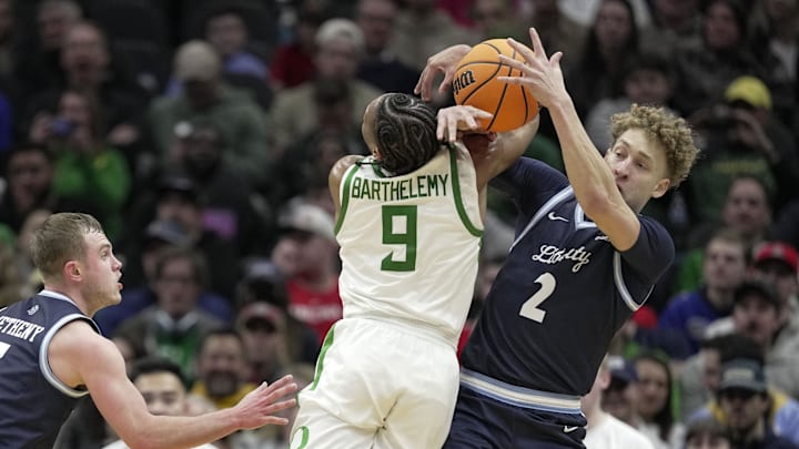 Mar 21, 2025; Seattle, WA, USA; Liberty Flames guard Taelon Peter (2) steals the ball from Oregon Ducks guard Keeshawn Barthelemy (9) during the second half in the first round of the NCAA Tournament at Climate Pledge Arena. Mandatory Credit: Stephen Brashear-Imagn Images Mar 21, 2025; Seattle, WA, USA; Liberty Flames guard Taelon Peter (2) steals the ball from Oregon Ducks guard Keeshawn Barthelemy (9) during the second half in the first round of the NCAA Tournament at Climate Pledge Arena. Mandatory Credit: Stephen Brashear-Imagn Images