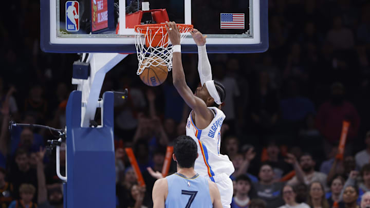 Mar 27, 2025; Oklahoma City, Oklahoma, USA; Oklahoma City Thunder guard Shai Gilgeous-Alexander (2) dunks in front of Oklahoma City Thunder forward Chet Holmgren (7) during the second half at Paycom Center. Mandatory Credit: Alonzo Adams-Imagn Images