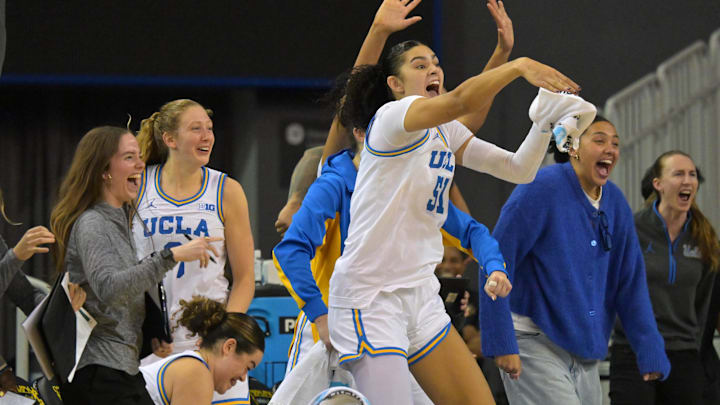 Dec 16, 2025; Los Angeles, California, USA; UCLA Bruins guard Charlisse Leger-Walker (5), guard Gianna Kneepkens (8) and center Lauren Betts (51) react on the bench after a basket during the second half against the Cal Poly Mustangs at Pauley Pavilion presented by Wescom Financial. Mandatory Credit: Jayne Kamin-Oncea-Imagn Images