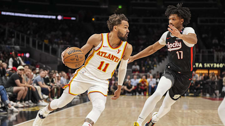 Apr 1, 2025; Atlanta, Georgia, USA; Atlanta Hawks guard Trae Young (11) dribbles against Portland Trail Blazers guard Shaedon Sharpe (17) during the first half at State Farm Arena. Mandatory Credit: Dale Zanine-Imagn Images