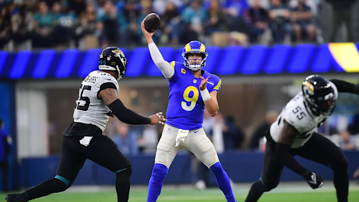 Dec 5, 2021; Inglewood, California, USA; Los Angeles Rams quarterback Matthew Stafford (9) throws as Jacksonville Jaguars defensive end Roy Robertson-Harris (95) moves in during the second half at SoFi Stadium. Mandatory Credit: Gary A. Vasquez-Imagn Images
