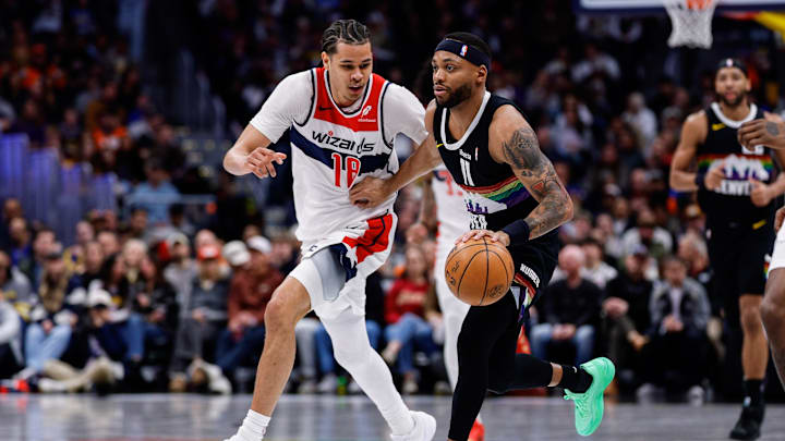 Jan 17, 2026; Denver, Colorado, USA; Denver Nuggets guard Bruce Brown (11) controls the ball ahead of Washington Wizards forward Kyshawn George (18) in the second quarter at Ball Arena. Mandatory Credit: Isaiah J. Downing-Imagn Images