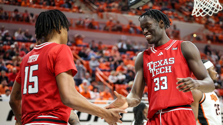 Feb 15, 2025; Stillwater, Oklahoma, USA; Texas Tech Red Raiders forward Federiko Federiko (33) slaps hands with Texas Tech Red Raiders forward JT Toppin (15) after a play during the second half against the Oklahoma State Cowboys at Gallagher-Iba Arena. Mandatory Credit: William Purnell-Imagn Images