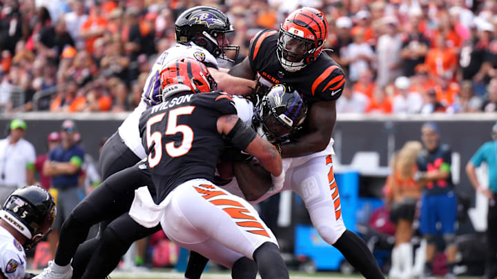 Baltimore Ravens running back Gus Edwards (35) scores a touchdown as Cincinnati Bengals linebacker Logan Wilson (55) and Cincinnati Bengals linebacker Germaine Pratt (57) defend in the first quarter of a Week 2 NFL football game between the Baltimore Ravens and the Cincinnati Bengals Sunday, Sept. 17, 2023, at Paycor Stadium in Cincinnati.