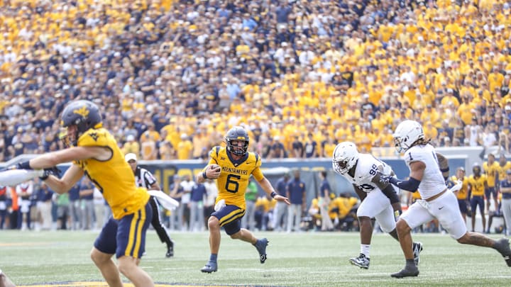 Aug 31, 2024; Morgantown, West Virginia, USA; West Virginia Mountaineers quarterback Garrett Greene (6) runs the ball during the second quarter against the Penn State Nittany Lions at Mountaineer Field at Milan Puskar Stadium. 